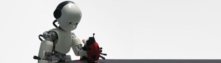 robotic baby called icub playing with toy